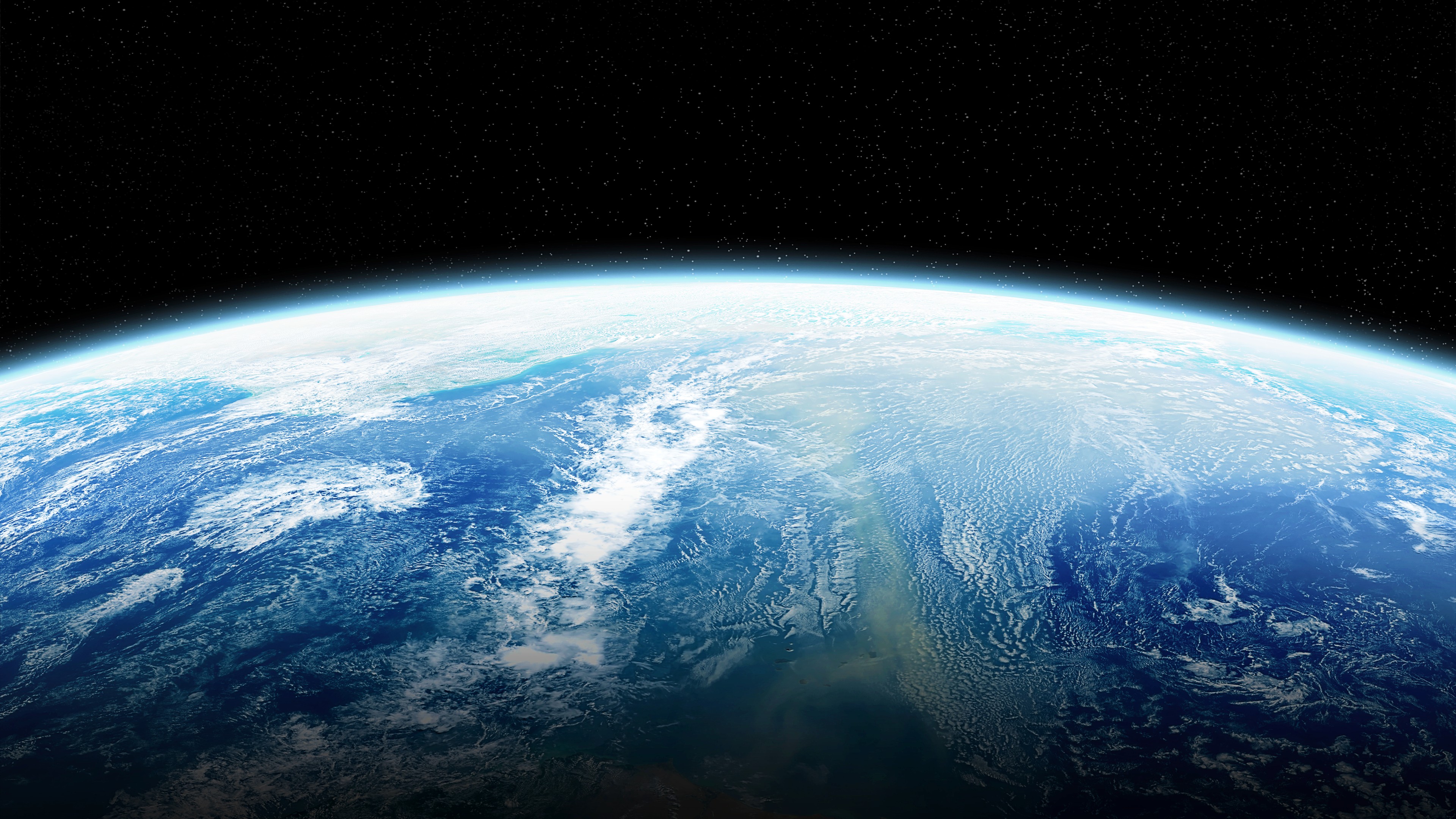 View of Earth from space showing a partially illuminated hemisphere with detailed ocean and cloud patterns against a backdrop of stars.