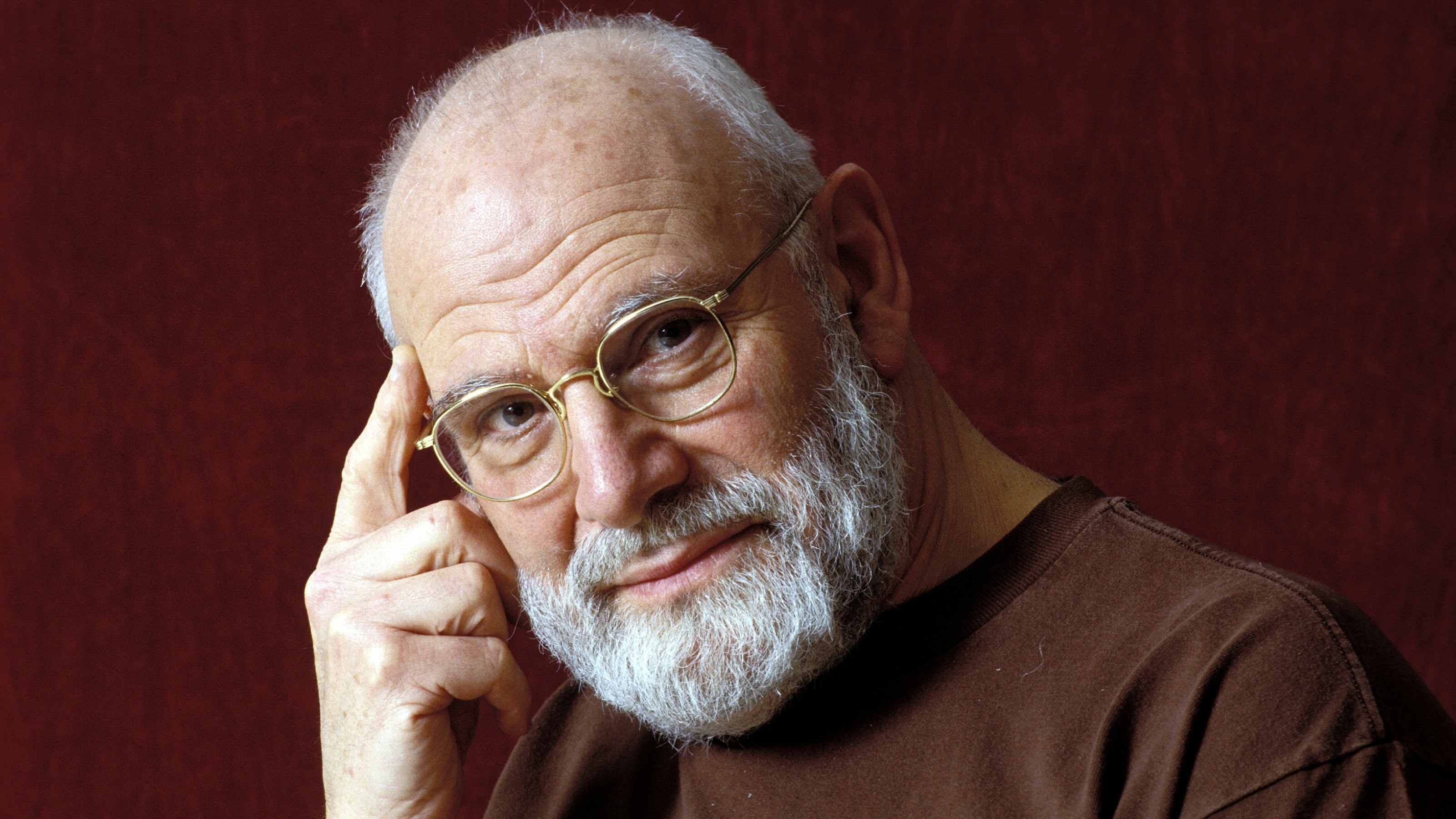 An older man with glasses and a beard posing for a picture.