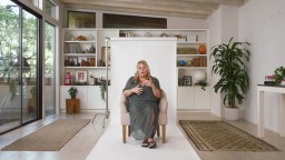 A woman sitting on a chair in a living room.